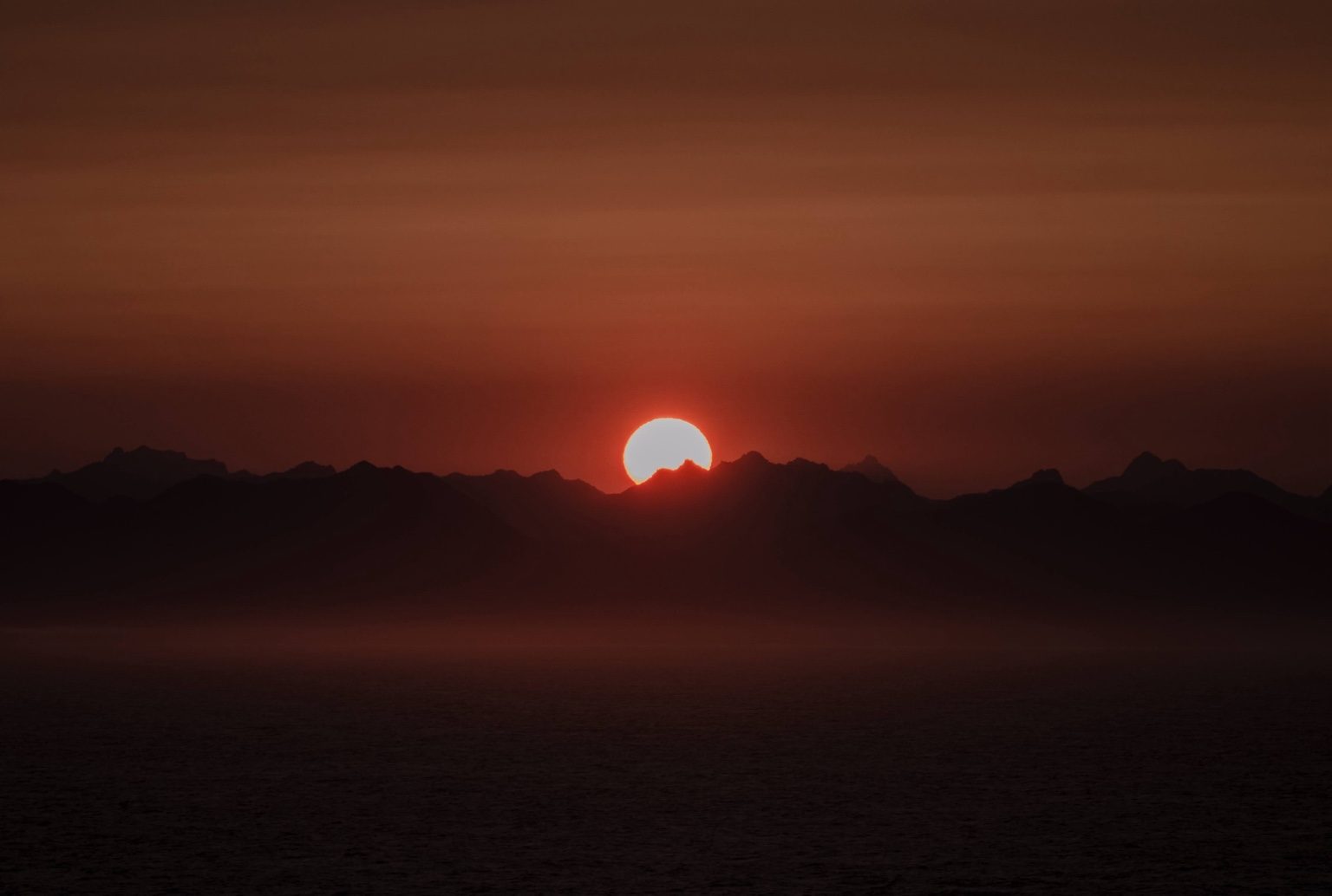 Sunset behind mountain ridge