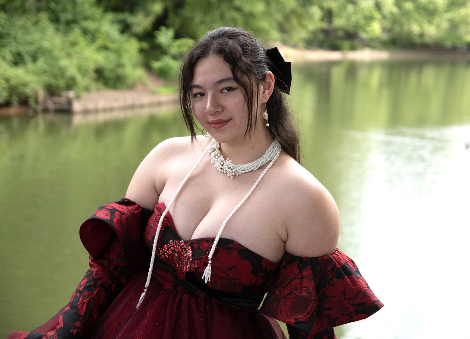 Red dress portrait by the water