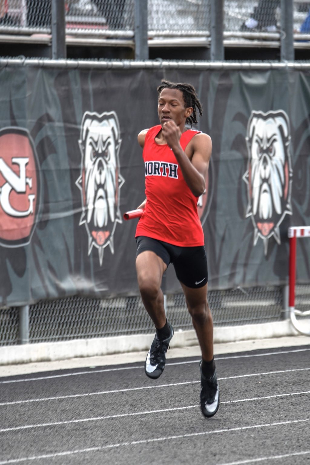 Relay runner mid-stride