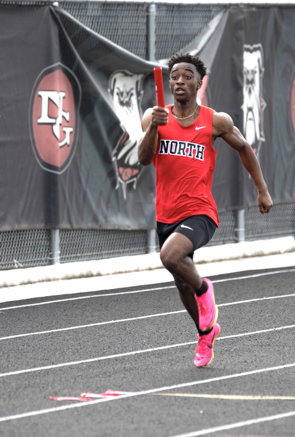 Track runner sprinting toward camera